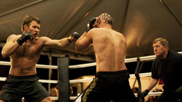 I'll hit you like a brother: Joel Edgerton (left) smacks it out in the mediocre fight film <i>Warrior</i>.