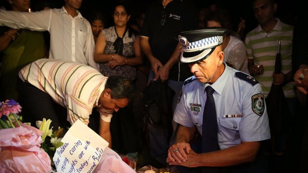  Police Superintendent Wayne Cox pays his respects at a memorial site for stabbing victim Prabha Arun Kumar at Parramatta on Wednesday. 