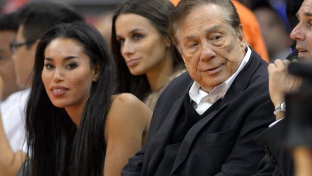 Los Angeles Clippers owner Donald Sterling, right, and V. Stiviano, left, watch the Clippers play the Sacramento Kings on Friday.