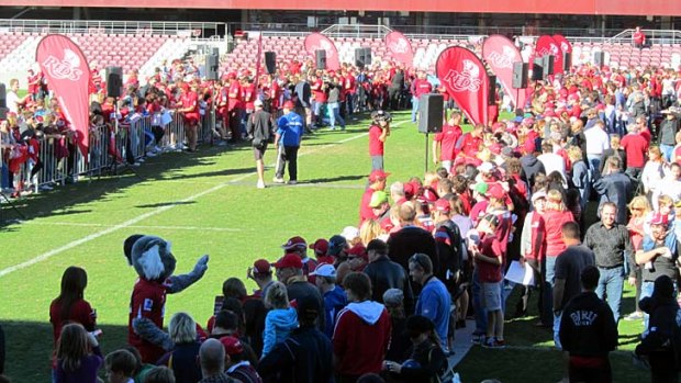 Reds fans line up to meet their heroes.