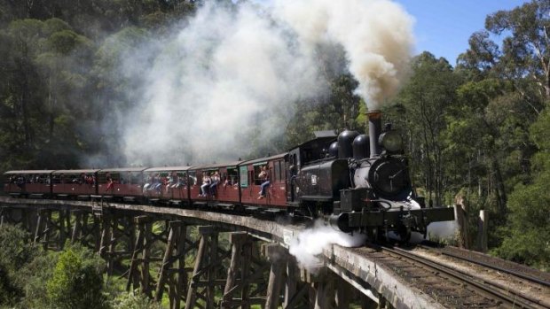 A Puffing Billy steam train hauled by locomotive 14A crosses the Monbulk Creek trestle after leaving Belgrave station near Melbourne.
