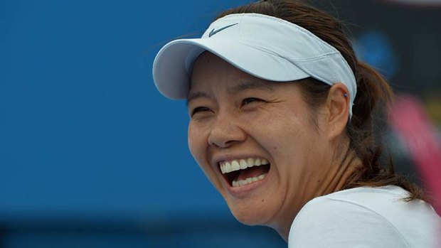 Li Na smiles during a practice session at Melbourne Park on Sunday.