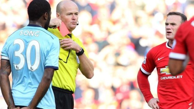 Referee Lee Mason banishes Wayne Rooney for hacking down Stewart Downing.