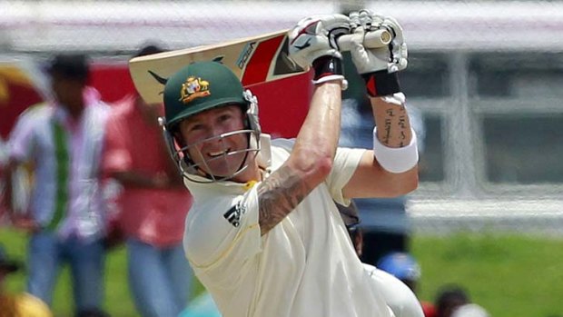 Michael Clarke smashes the ball into the off-side field.