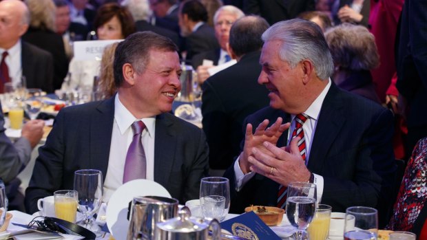 Jordan's King Abdullah, left, talks with US Secretary of State Rex Tillerson during the National Prayer Breakfast, on Thursday.