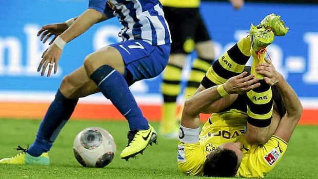 Down for the count: Dortmund's Sebastian Kehl lies on the pitch after challenging Berlin's Hajime Hosogai.