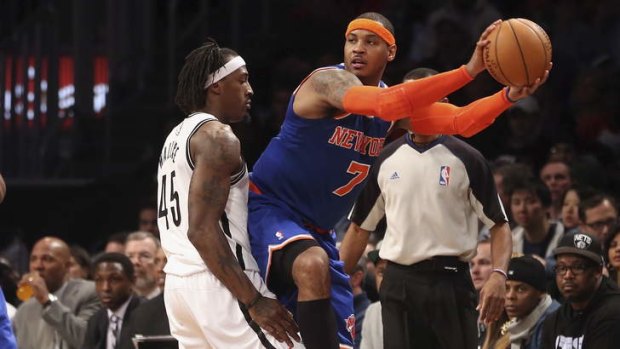 Under the microscope: New York forward Carmelo Anthony looks to pass while Gerald Wallace of the Brooklyn Nets tries to prevent his opponent dishing off.
