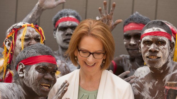 Gather round: Julia Gillard enjoys her time with a dance troupe made up of inmates from a Darwin prison.