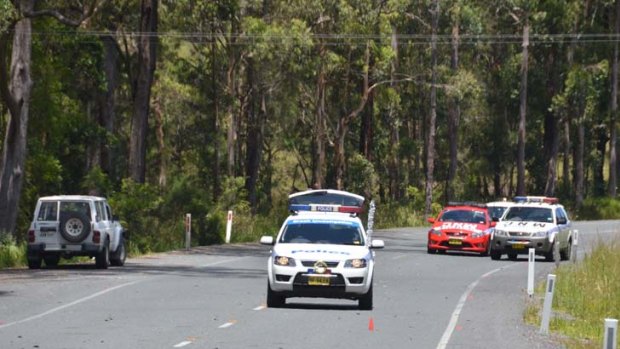 Inquiry ... the Nissan Patrol, left, involved in the death of two hitchhikers remains at the scene of the incident on the Oxley Highway.