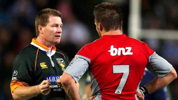 Referee Stuart Dickinson talks to Crusaders captain Richie McCaw during the match against the Stormers.