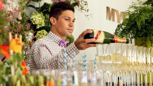 A bartender gets ready for an event in the Myer tent.