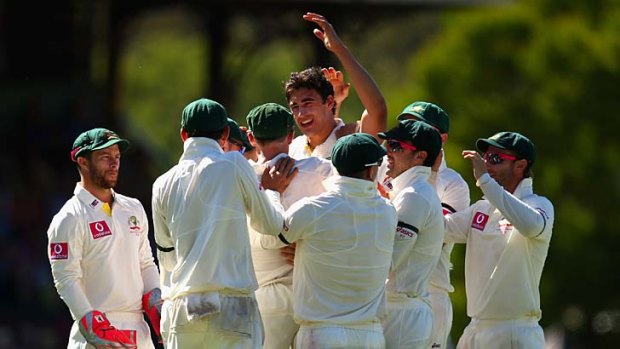 Back to business: Mitchell Starc and teammates celebrate the wicket of Angelo Mathews.