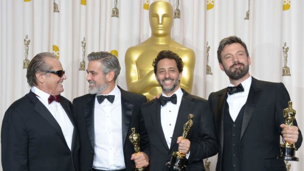 Ben Affleck (R), George Clooney (2nd L), Grant Heslov (2nd R) and presenter Jack Nicholson celebrate winning the trophy for Best Picture for Argo at the 85th Annual Academy Awards.