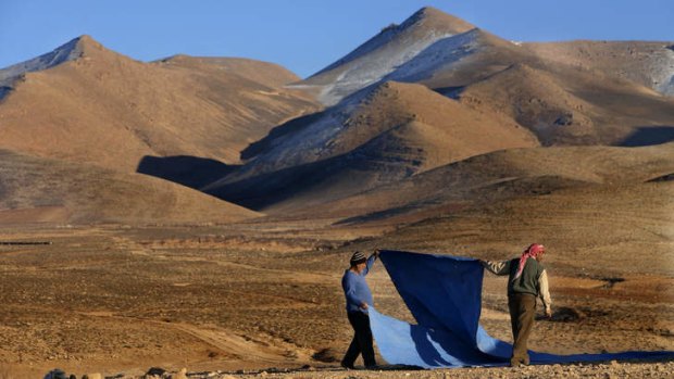 On the run: Two Syrian men who fled from Yabroud set up their tent near eastern Lebanon.