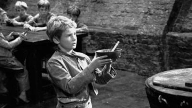 British child actor Mark Lester as Oliver Twist asking for some more gruel during the filming of <i>Oliver</i>, circa 1967.