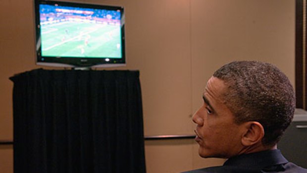 Cheer leader ... US President Barack Obama watches the match.