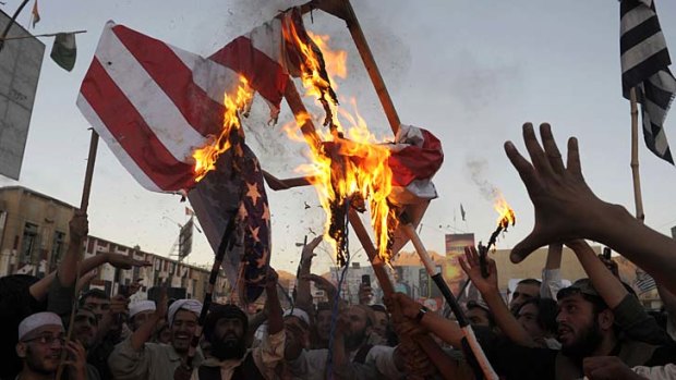 Angry: Pakistani Muslim demonstrators burn a US flag in Quetta to protest against an anti-Islam film that has been circulating on YouTube.