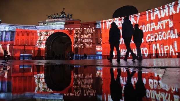 People watch a light show marking the centenary of the Bolshevik Revolution at Dvortsovaya (Palace) Square in St.Petersburg, Russia.