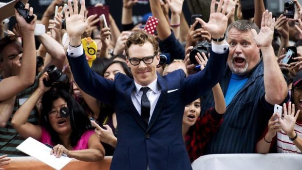 Actor Benedict Cumberbatch poses for photographs on the red carpet for <i>The Imitation Game</i> during the 2014 Toronto International Film Festival.