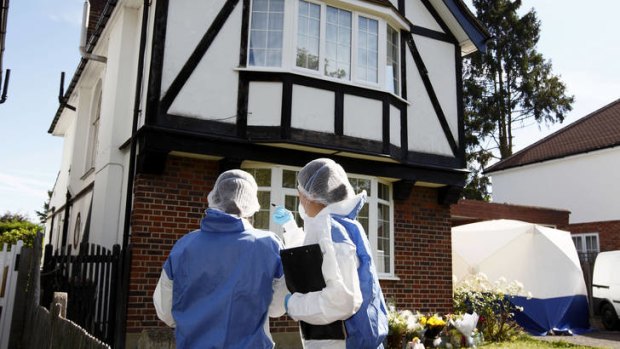 Searching the victims' home ... British forensic officers conduct investigations outside a house in Claygate, south-east England.
