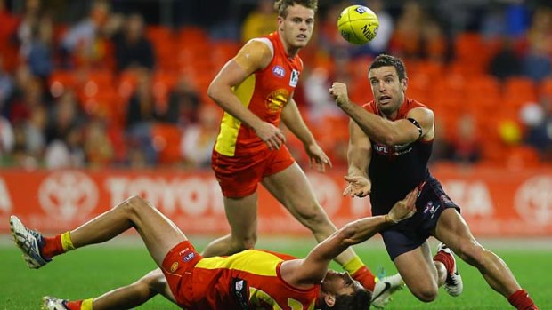 Ball up: Melbourne's Shannon Byrnes tries to evade Suns rivals.