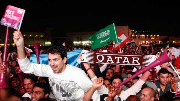 Party time ... locals celebrate FIFA's announcement in Qatar.
