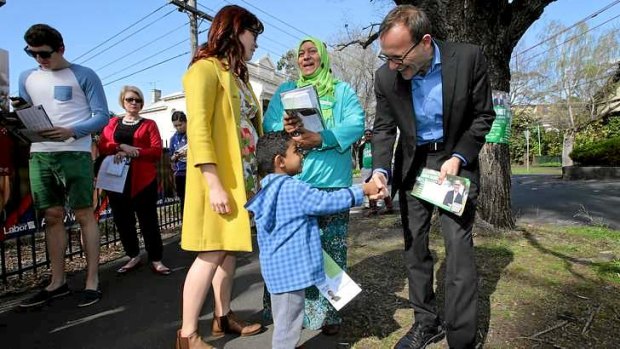 Greens member for Melbourne Adam Bandt greets Aseel Barabiaa at Mt Alexander College polling booth.