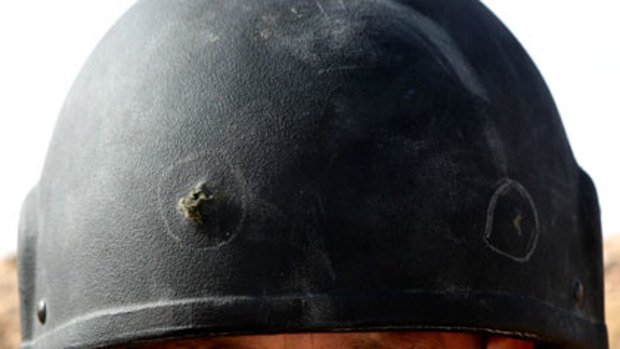 Close call ... Private Leon Wilson and his bullet-holed helmet.