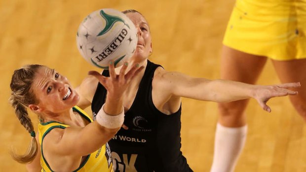 Caitlin Bassett of the Diamonds receives the ball against New Zealand's Katrina Grant.