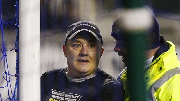 Having his say ... a man handcuffed himself to the goalpost during the match between Everton and Manchester City.