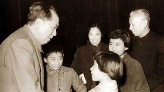 The good old days ... Mao Zedong shakes hands while the young Liu Yuan (immediately right of Mao) looks on, with his parents and sisters.