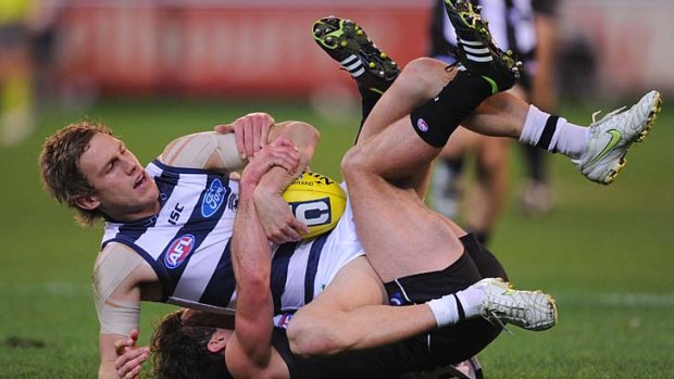 Geelong's Billie Smedts is brought down by Collingwood's Jarryd Blair at the MCG on Saturday.