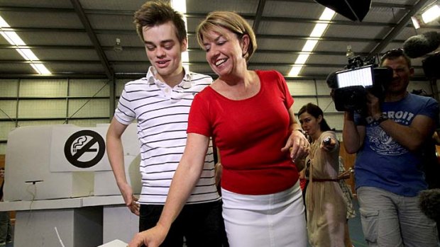 Queensland Premier Anna Bligh casts her vote with son Oliver, 19, at West End State School.