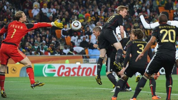 Close shave . . . Germany's goalkeeper Manuel Neuer tries to catch the ball as German players block the Ghanain attackers.