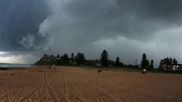 Bathers make a run for it as a severe storm bears down on Newport, on Sydney's Northern Beaches on Sunday.