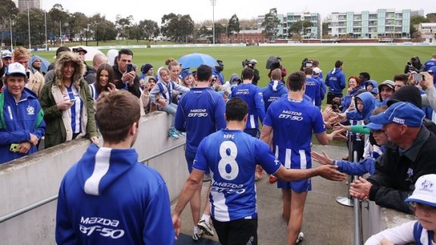 Kangaroos fans show their support as players head out during a North Melbourne training session at the Arden Street Ground on Thursday.
