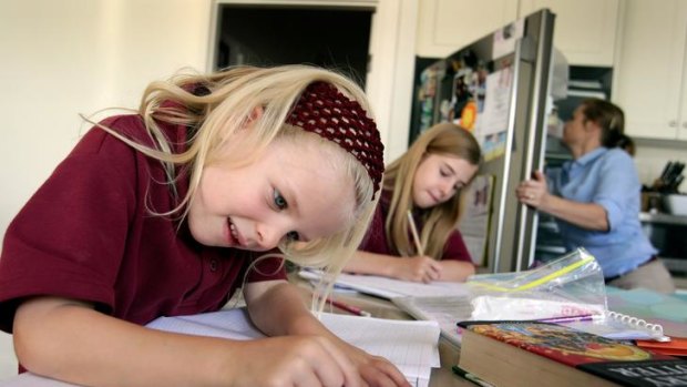 Paris and Scarlett Mansell stay focused on their homework. The Education Department recommends grade four students do no more than 30 minutes of homework a day.