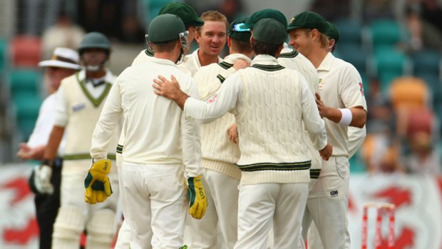 Australian players celebrate the wicket of Sarfraz Ahmed after he was caught by Michael Clarke off the bowling of Nathan Hauritz.