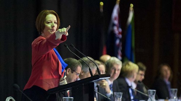 Prime Minister Julia Gillard speaks with locals during a public forum after a community cabinet meeting at Redbank Plains State High School, west of Brisbane.