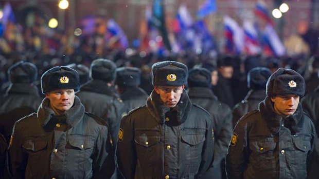 Standing guard ... Russian police officers form a cordon during a victory rally for  Vladimir Putin.