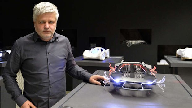 Slovak engineer Stefan Klein posing with his car models in Bratislava.