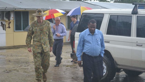 General Angus Campbell (in fatigues) with police chief Alex N'Drasal (front right).