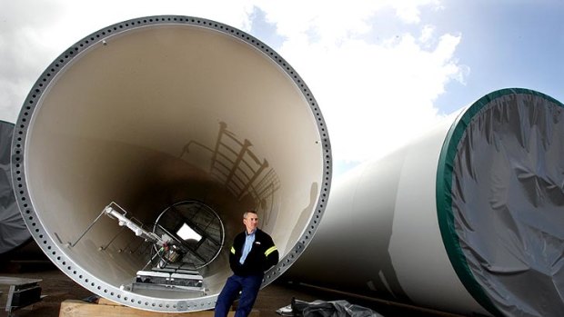 Winds of change: Stuart Batten in front of wind towers in Portland.