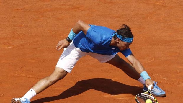 Nadal stretches to hit a return to Roger Federer.