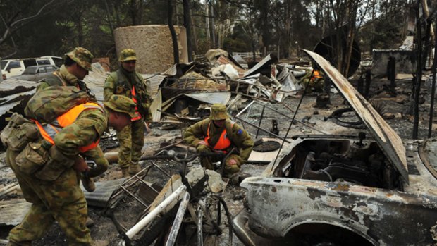 Scene of devastation...soldiers from the Victorian Search Task Group inspect properties and looks for bodies in Flowerdale.