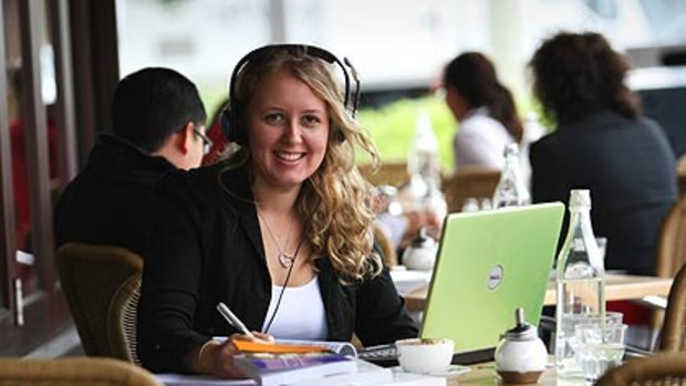 Monash University economics-law student Evelyn Young enjoys a coffee while listening to lectures downloaded on to her laptop.