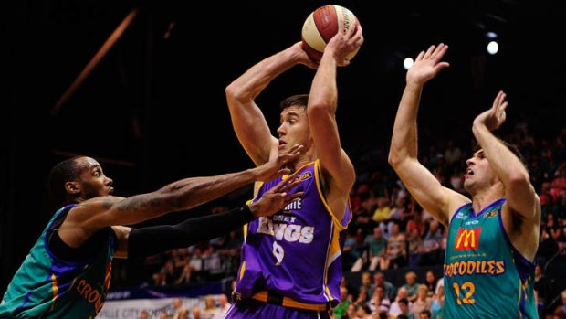 Sydney's Brad looks to pass the ball away from Josh Pace and Todd Blanchfield of the Crocodiles during the round four NBL match in Townsville.