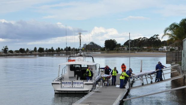 Police bringing ashore the bodies of a 12-year-old girl and an elderly couple who drowned near Batemans Bay.