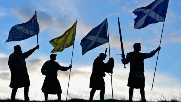 Members of the King of Scots Robert the Bruce Society hold Scottish flags ahead of Thursday's referendum.