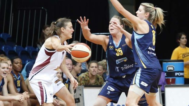 Logan Thunder's Laurie Koehn is blocked by Canberra Capitals Brigette Ardossi and Carly Wilson